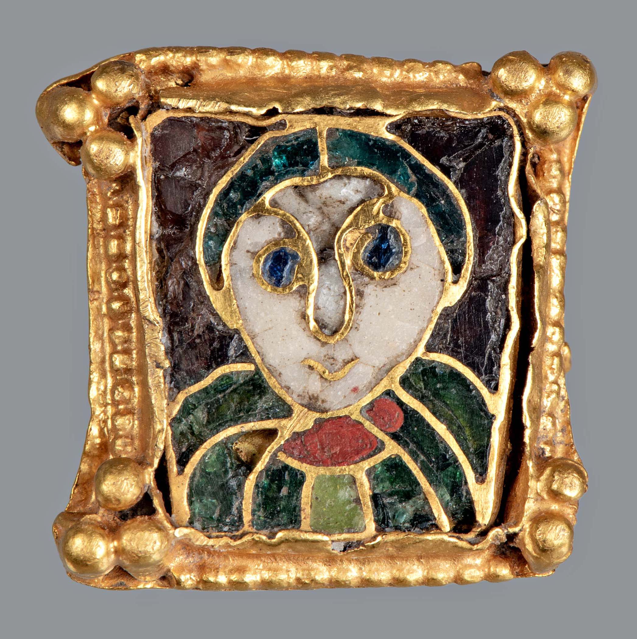 Mantelspeld met mannenkopje