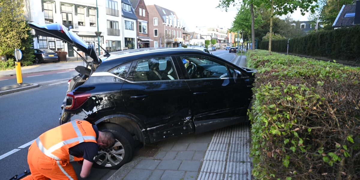 Auto komt in heg tot stilstand na botsing